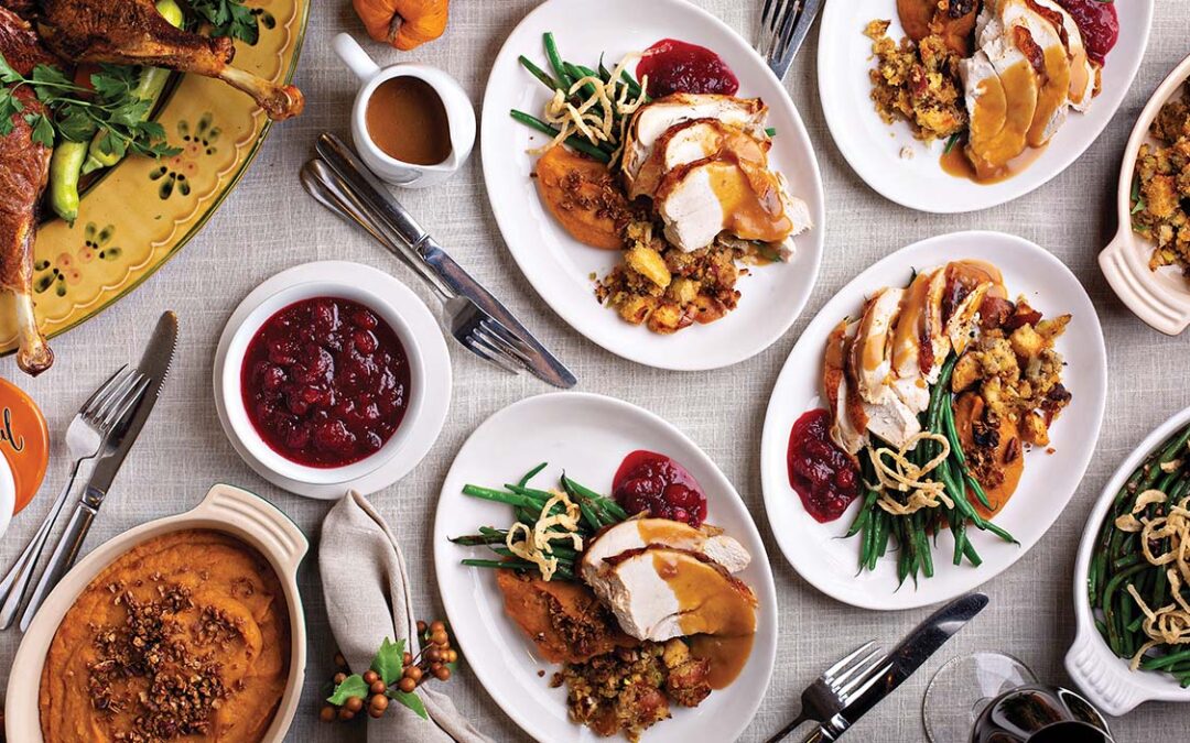 Festive Thankgiving dinner table with plates of food